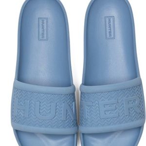 BRAND NEW WITH TAGS MEN’S BLUE FOAM SLIDES in size 10.